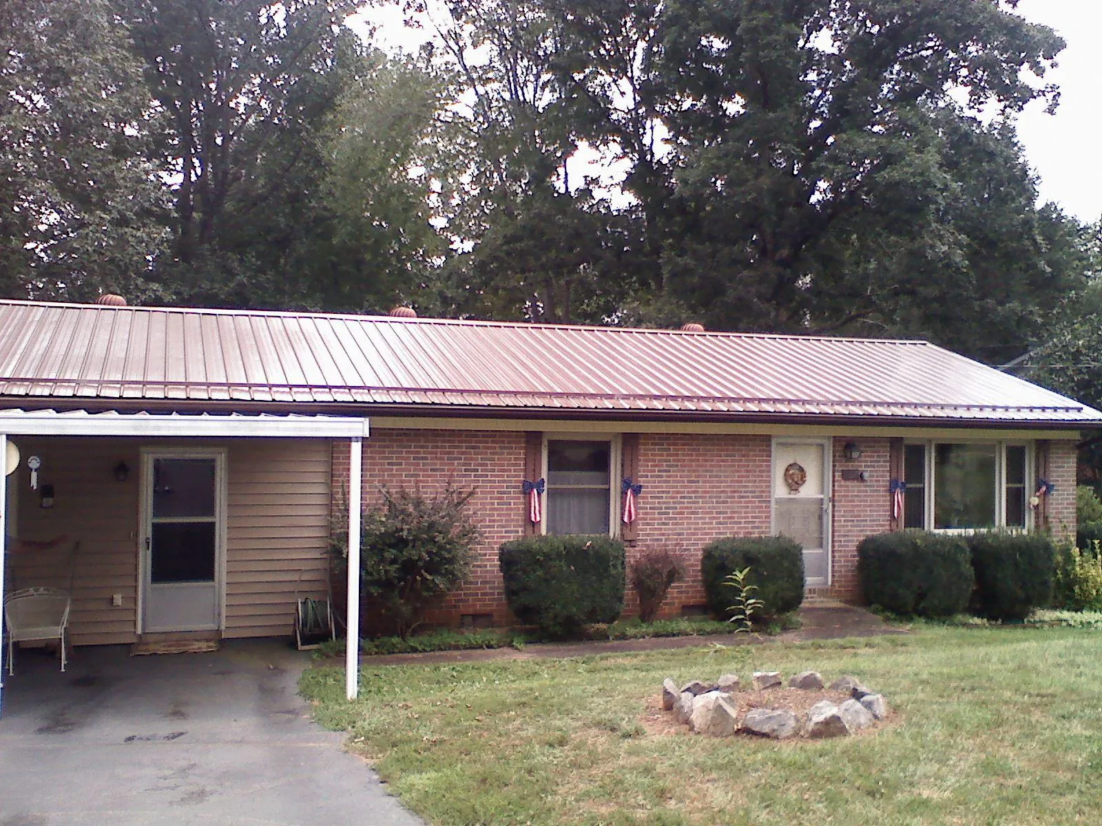Bronze metal roof and carport on a brick ranch home — Roof Repair work by our crew in Fruitvale